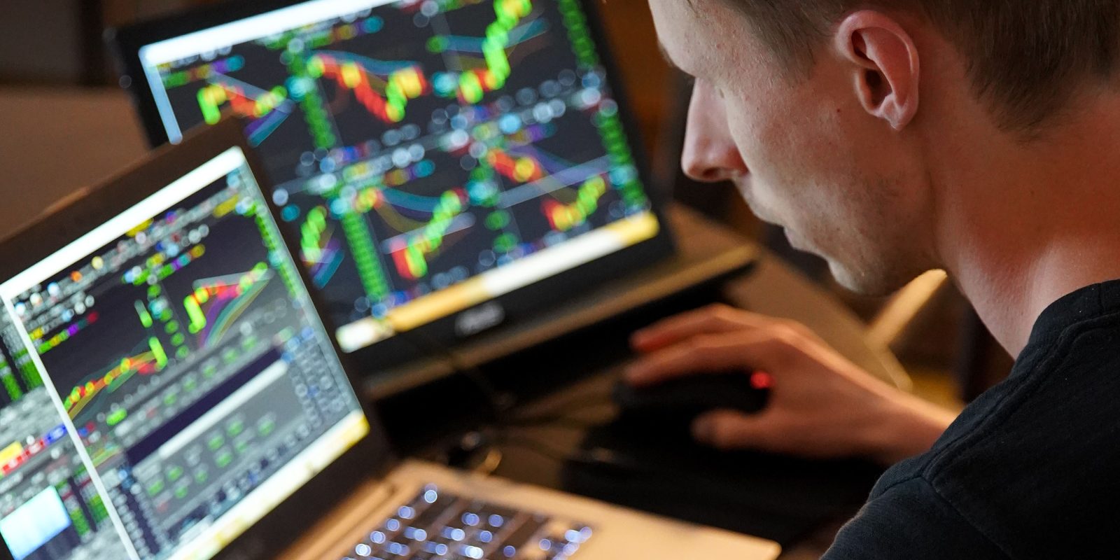 Man studying graphs on laptops | AAPL Q3 2022 will be tough for five reasons