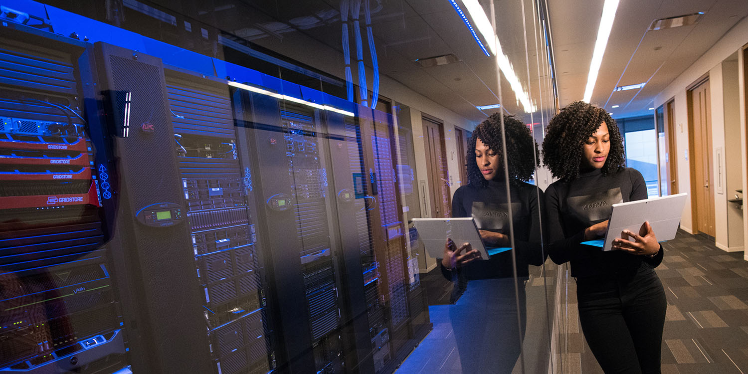 Photo of woman using a MacBook in a data center | Apple's CSAM troubles may be back