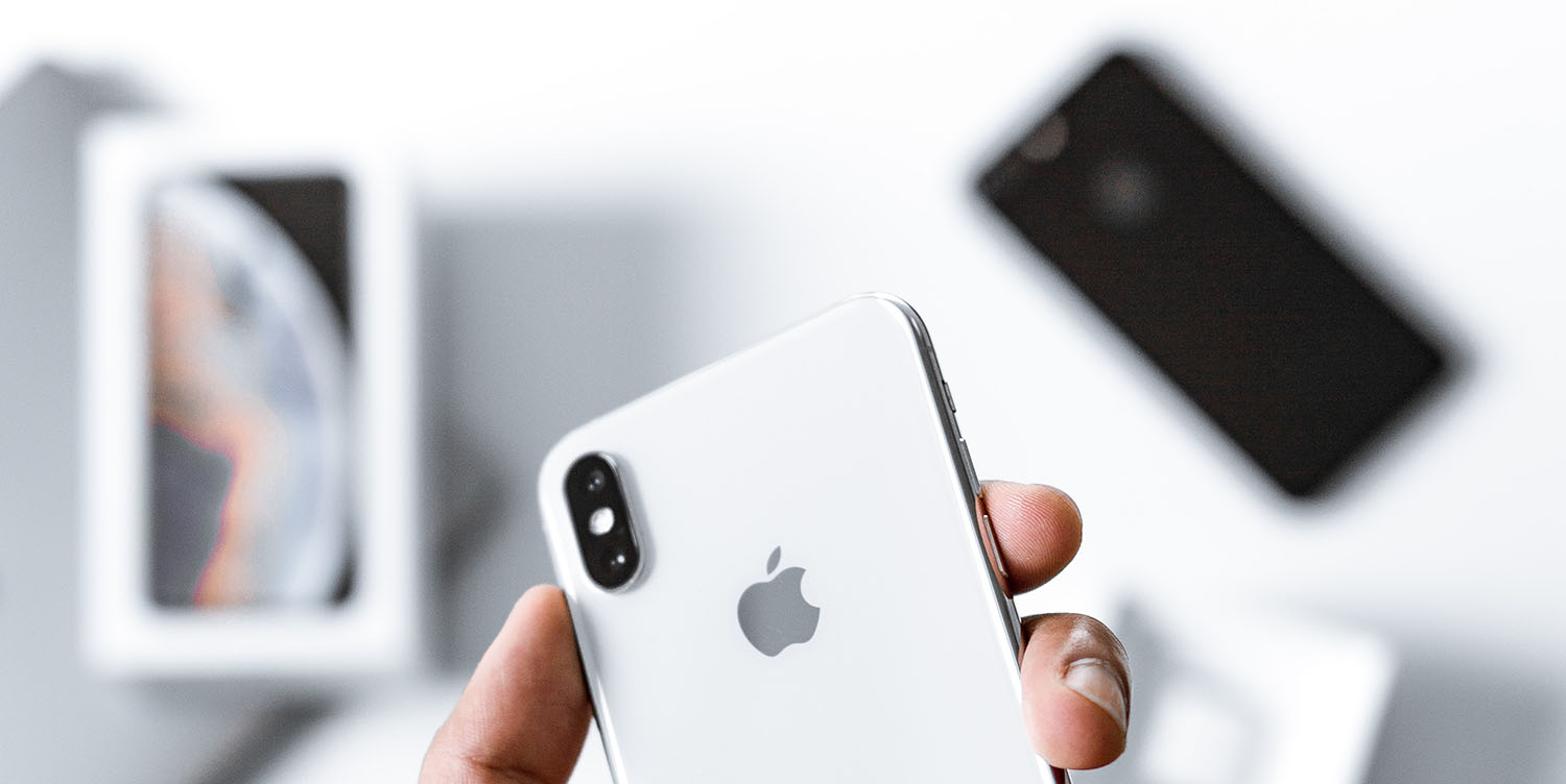 European smartphone shipments fall, but Apple grows market share | Photo shows hand holding iPhone