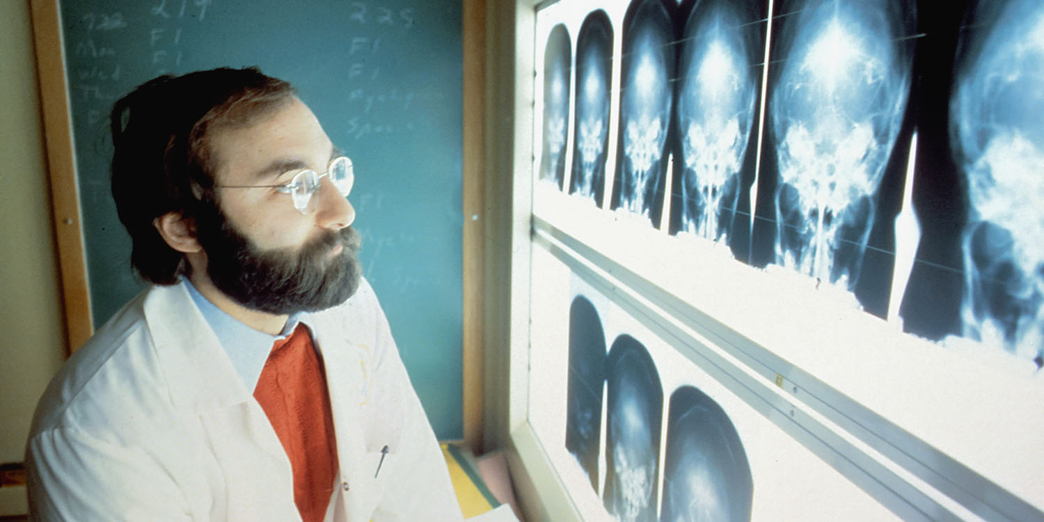 AFib History | A doctor examines skull x-rays