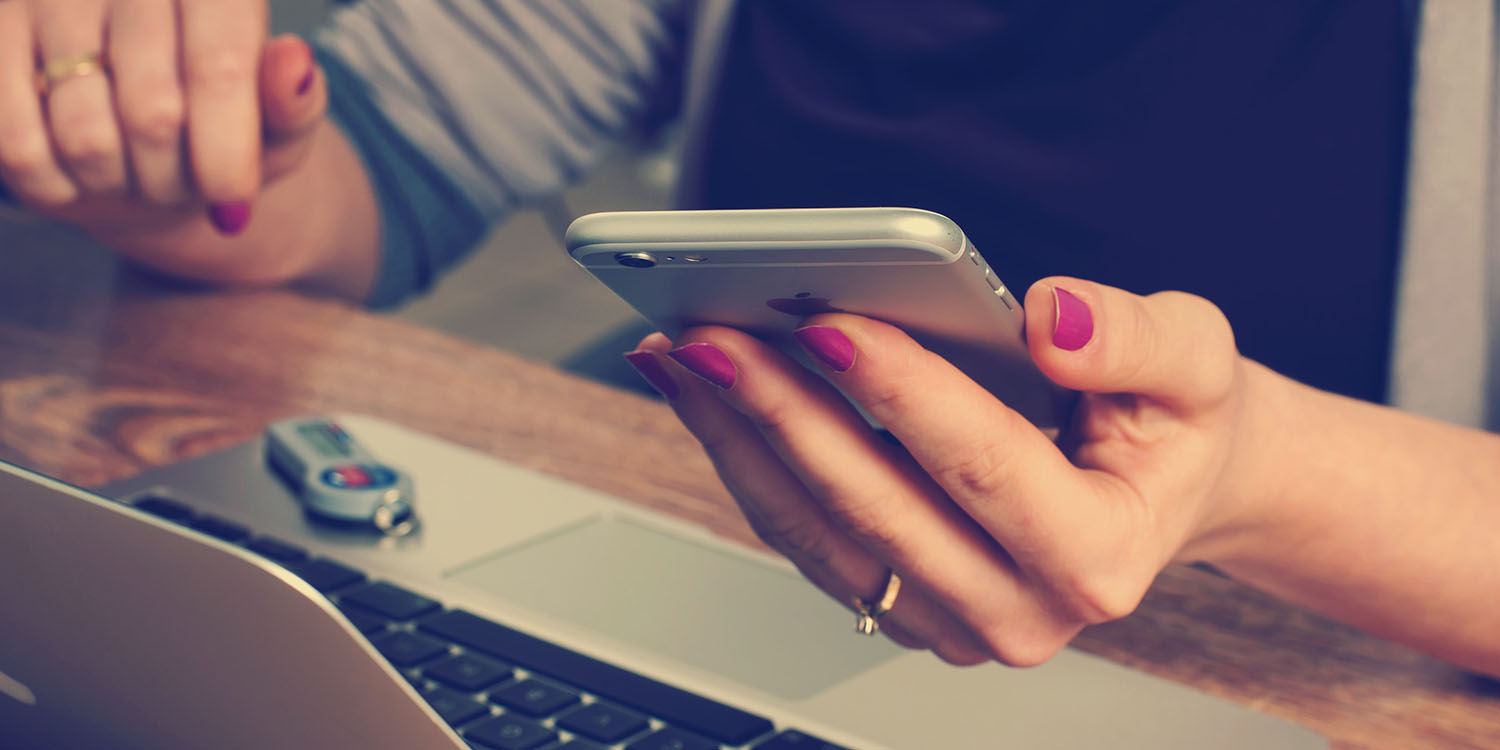 Period tracking apps | Cycle tracking apps | Close-up of a woman's hand, holding an iPhone