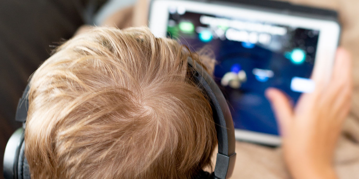 Autistic child | Stock photo showing child using iPad