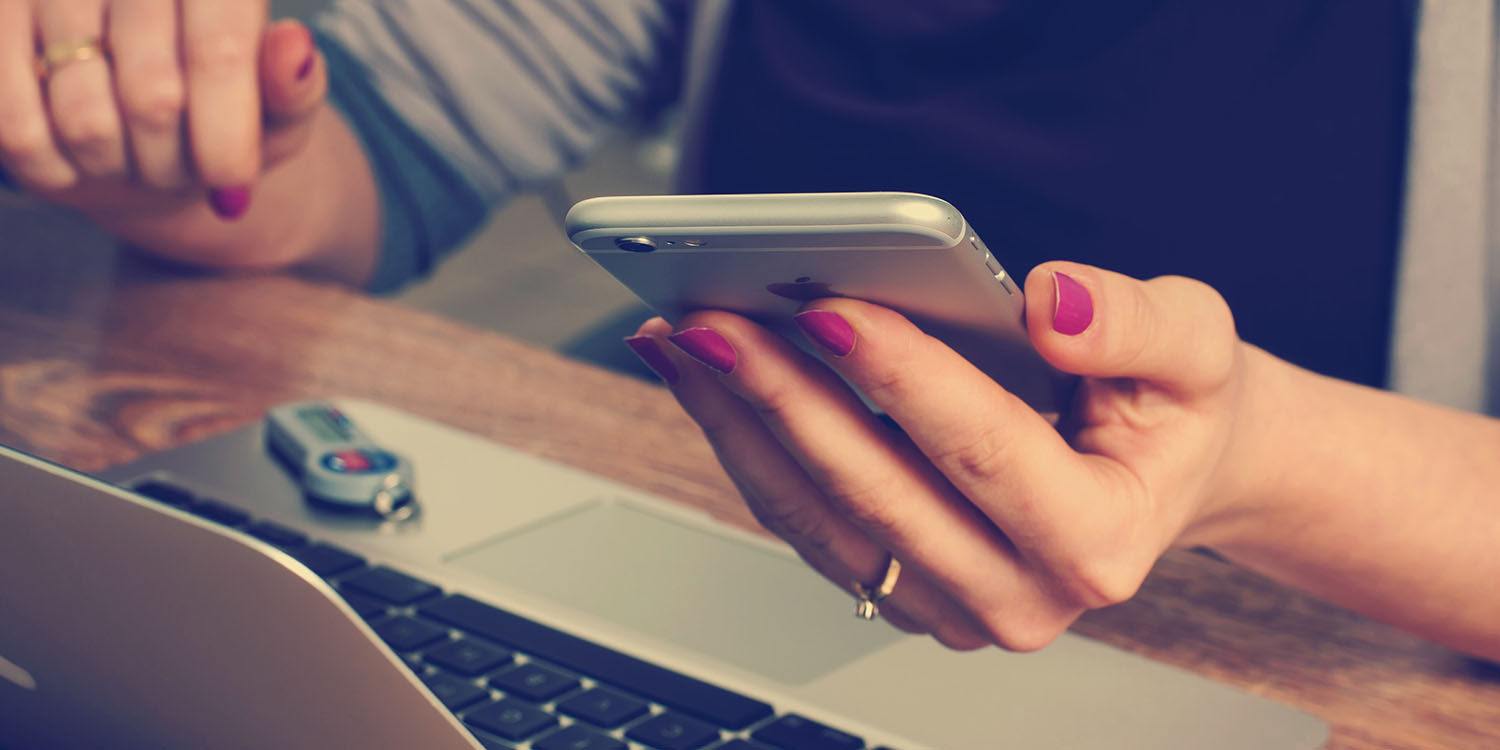 Apple recruitment | Close-up of woman reading message on her iPhone