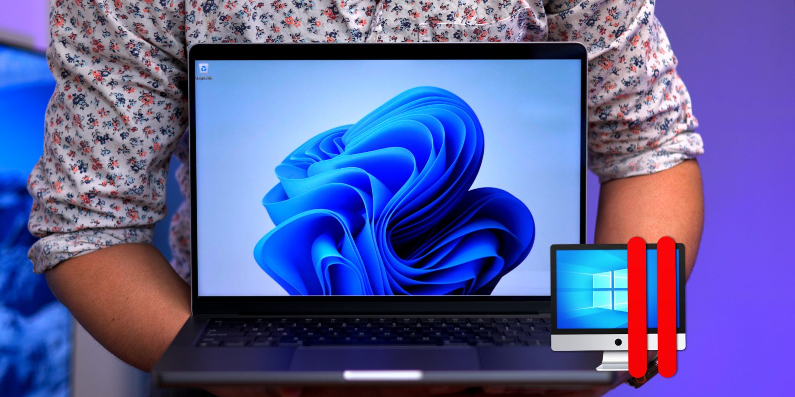 A person holding a MacBook Pro with Apple Silicon running Windows 11 with Parallels Desktop 18.