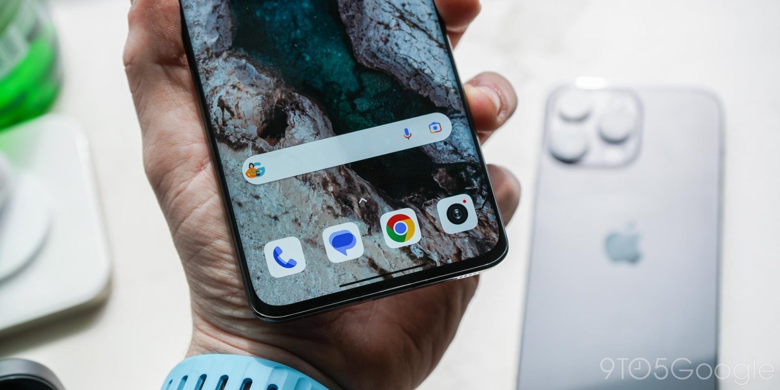 Picture of phone with Google Messages in front of iPhone