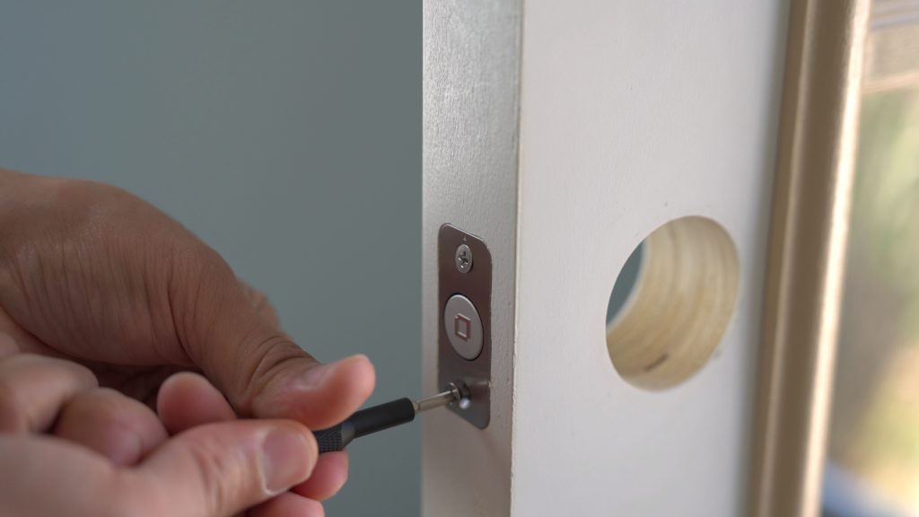 Level Lock+ deadbolt installation, screwing it in.