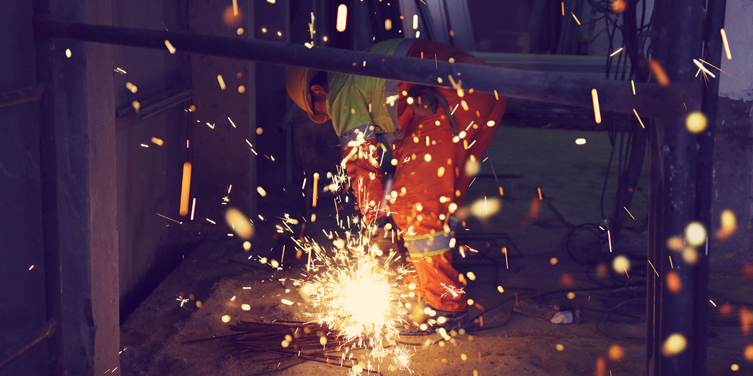 TSMC Arizona chip plant delay | Construction worker using a welder