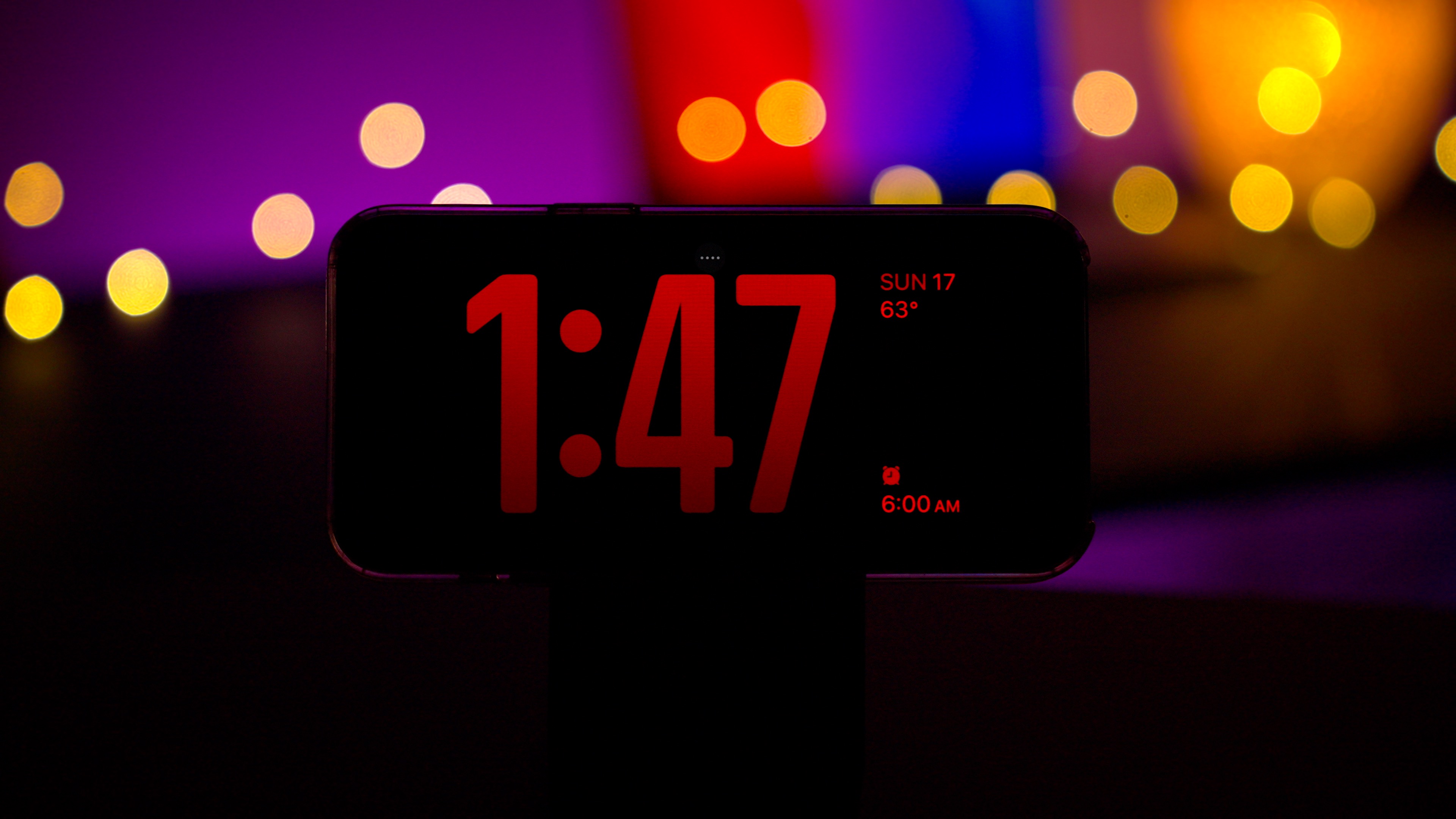StandBy in iOS 17 showing a clock in Night mode.