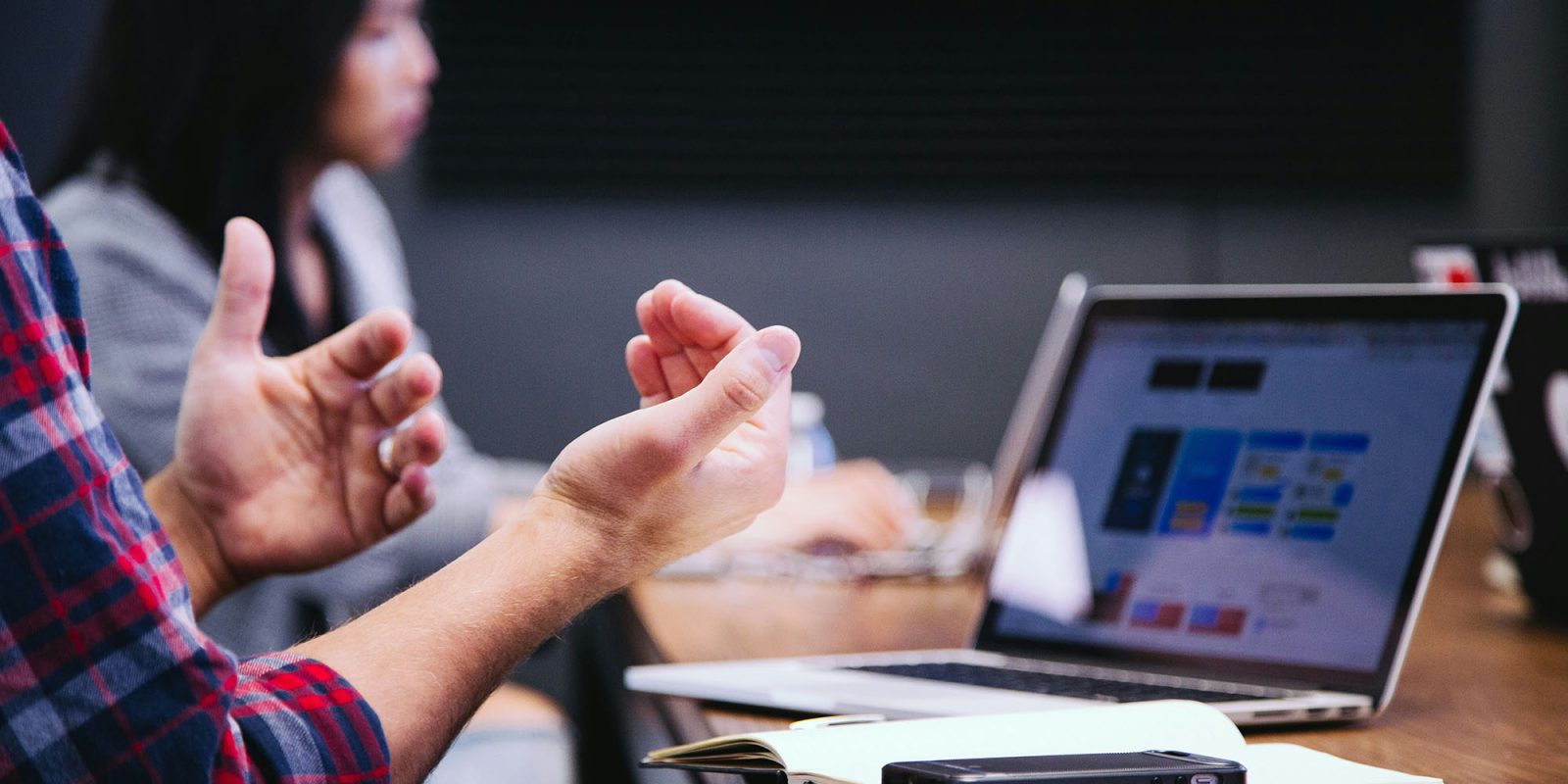 US antitrust suit decision close | Man and woman making their case in a meeting