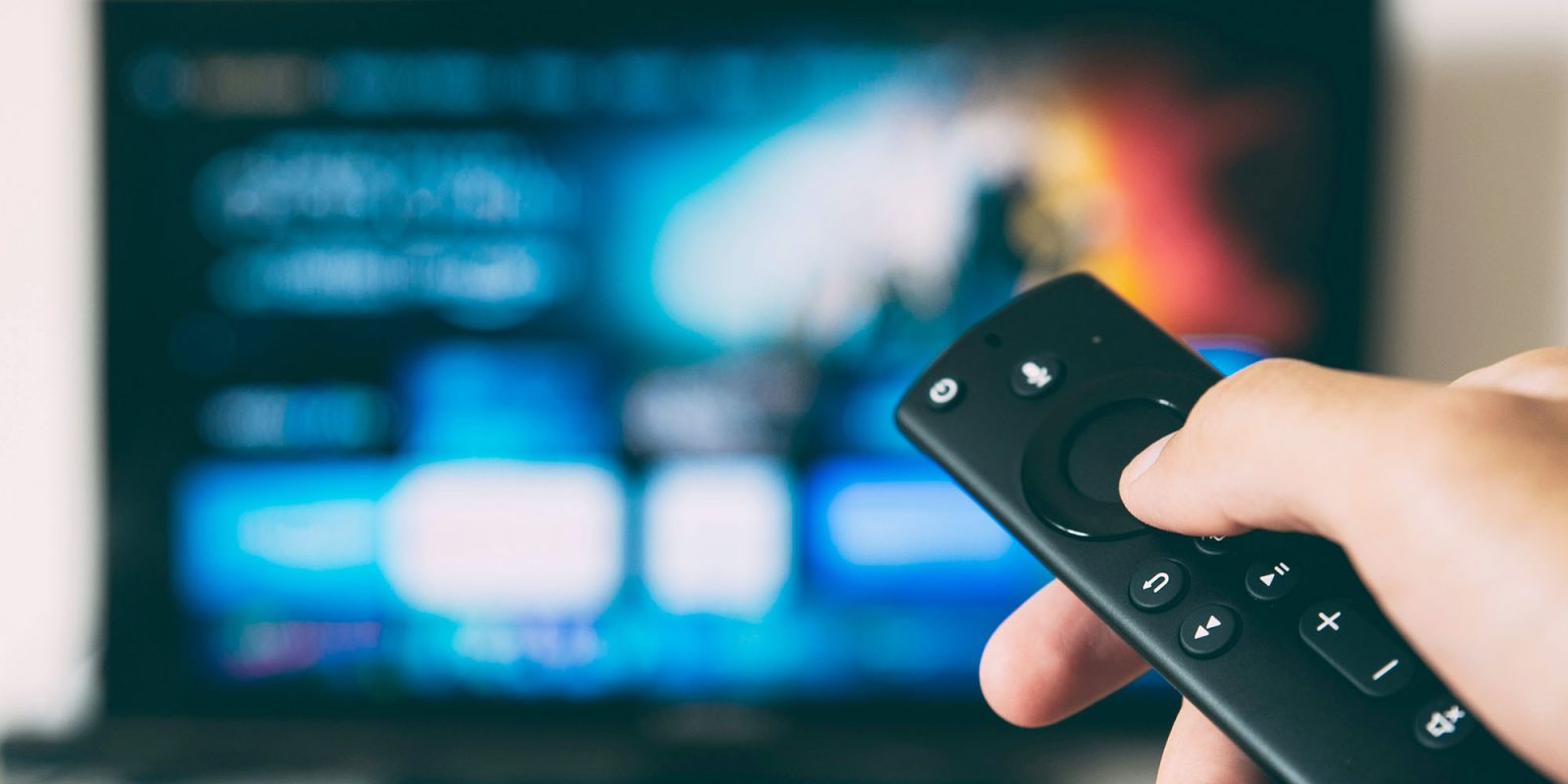 Disney+, Hulu, Max bundle | Siri remote in front of out-of-focus TV