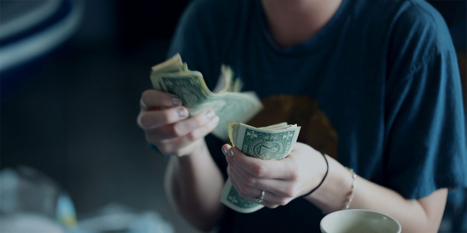 In-app subscriptions | Woman counting dollar bills