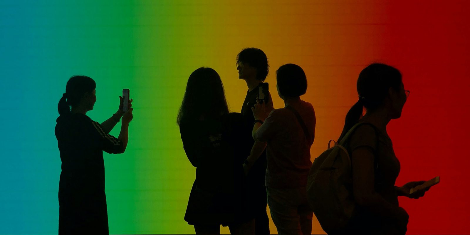 Apple trade-in values cut | Silhouette of visitors to an Apple Store