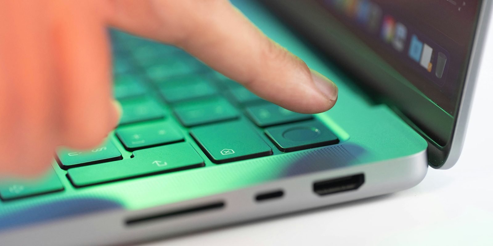 Passkeys were supposed to be secure and simple; here's how they fail | Close-up of a finger about to press the Touch ID button on a MacBook