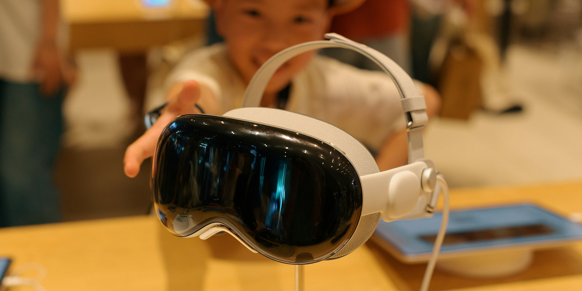 Vision Pro strategy will succeed, predicts TrendForce, as Apple creates two-tier market | Child reaching for a display model in an Apple Store
