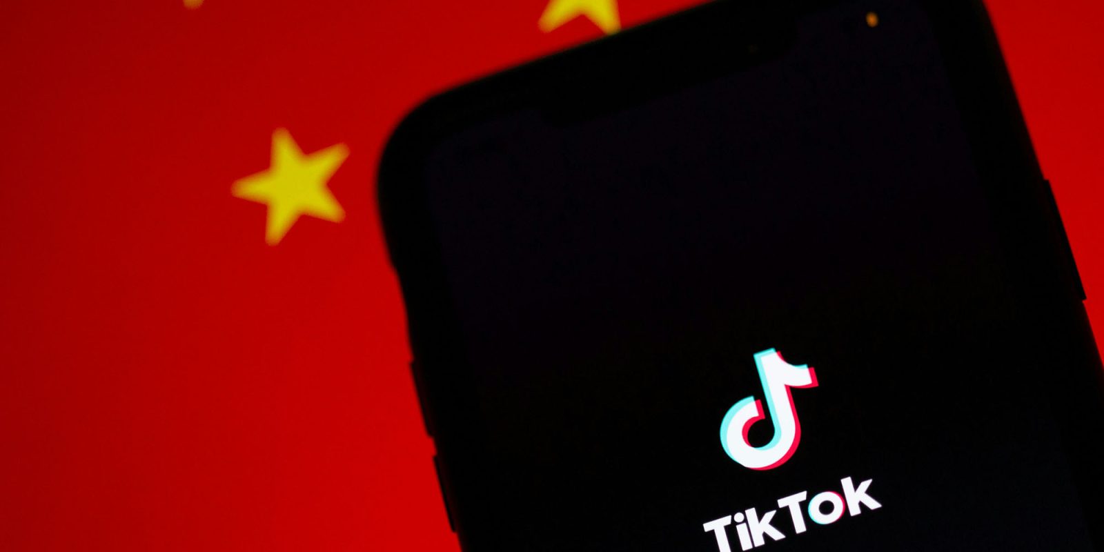TikTok ban could be resolved without selling to a US company, says American board member | App shown on an iPhone in front of a Chinese flag
