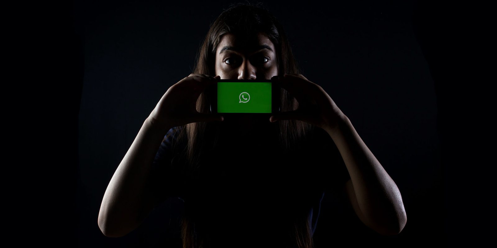 Zero-click WhatsApp spyware targeted 90 journalists, says Meta | WhatsApp on a phone held in front of a woman's mouth