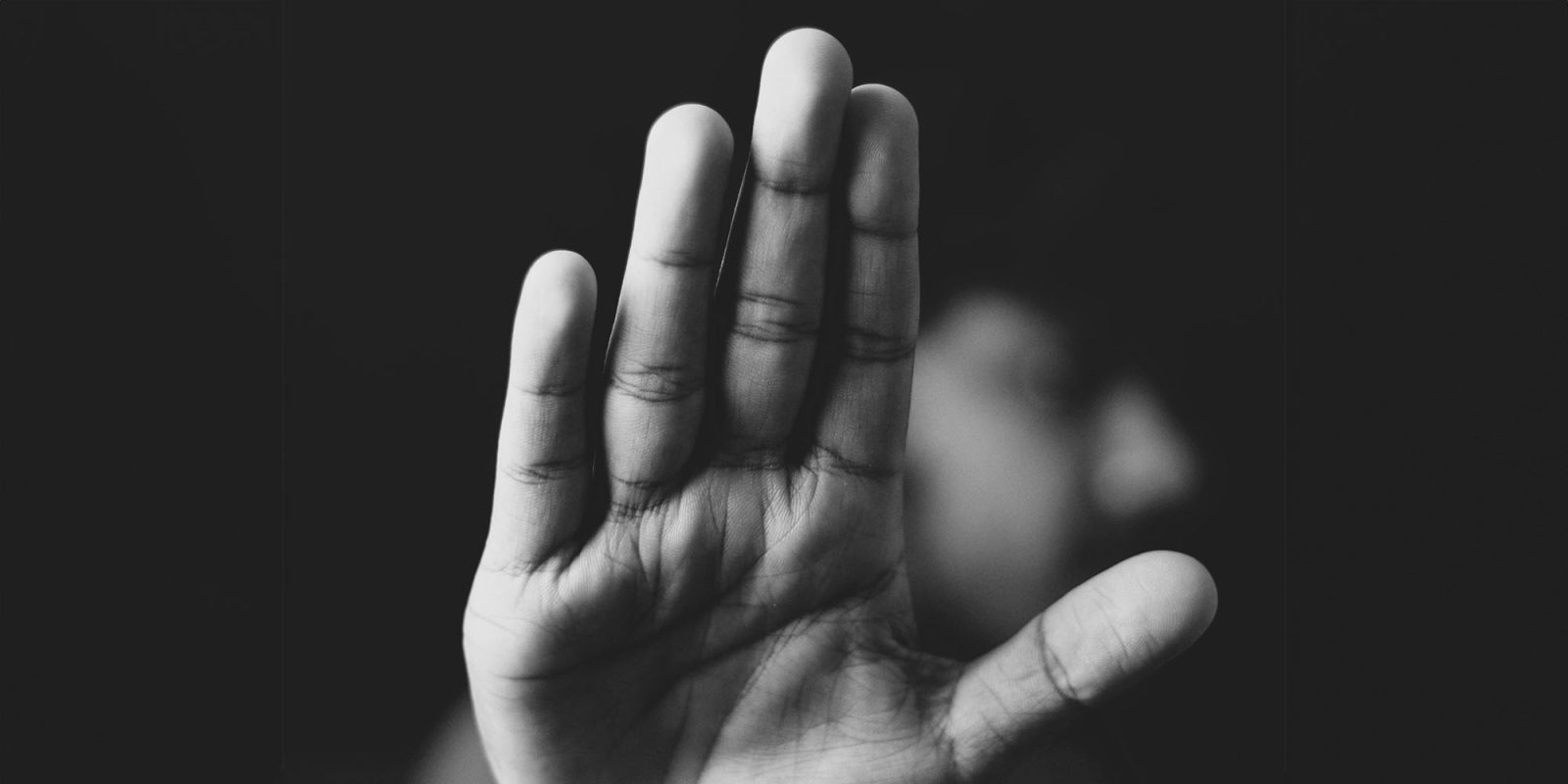 Secret court hearing on iCloud encryption underway amid demands to make it public | Hand held up in 'keep away' gesture