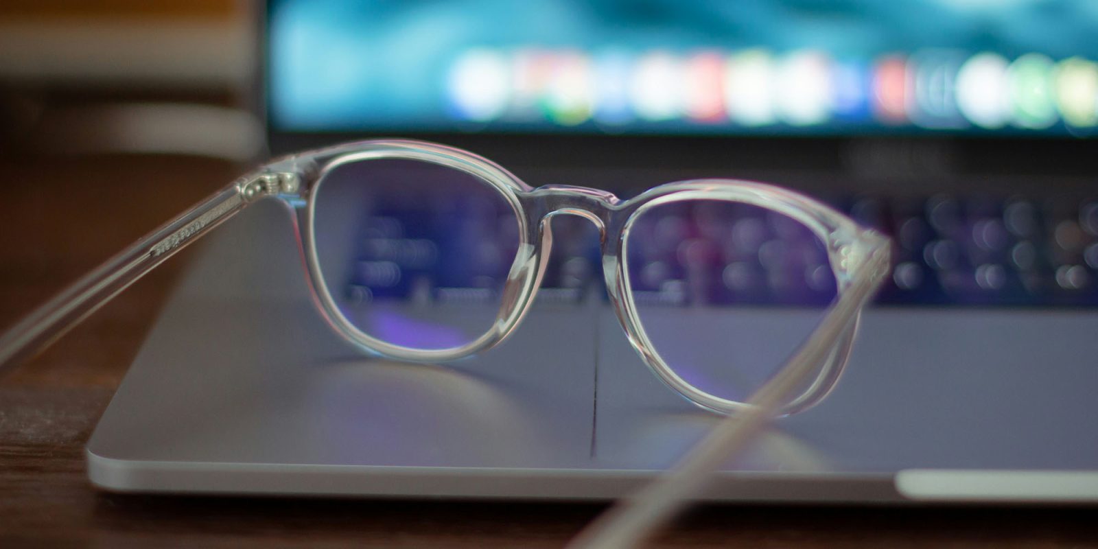 Apple Glasses race heats up as Meta changes its headset plans | Standard eyeglasses shown resting on a MacBook