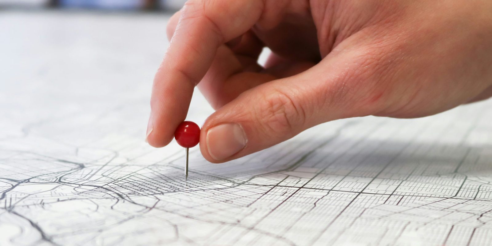 Many Gen Z use Find My and other apps to share their location with friend groups 24/7 | Photo shows a hand placing a pin in a map