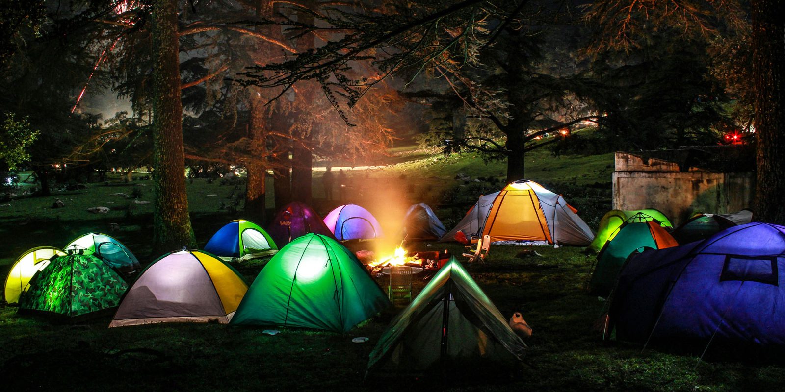 The $2,000 per week summer camps aiming to cure teens of phone addiction | Brightly-colored tents in a forest at night