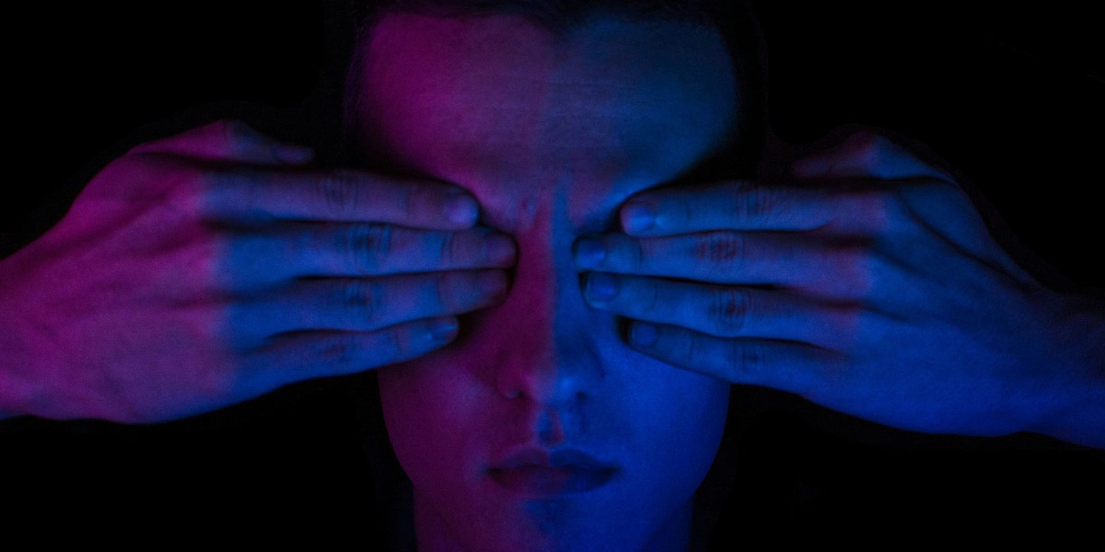 US government seeks tool to find 'hidden language' in messages on your phone | Low-key colorful photo shows hands over eyes