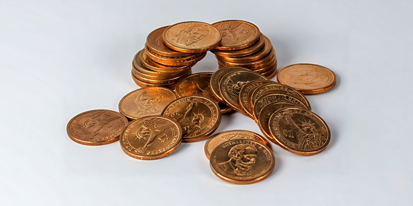 Why Apple is fighting legal battles in two countries over 12 cents per iPhone | A pile of coins on a table