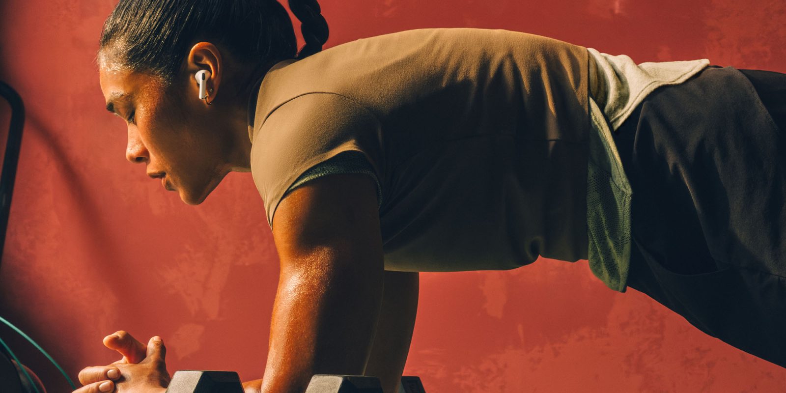 AirPods Pro 3 heart rate monitoring 'mind-bogglingly good' – unlike PowerBeats 2 Pro | A woman wearing them during a workout