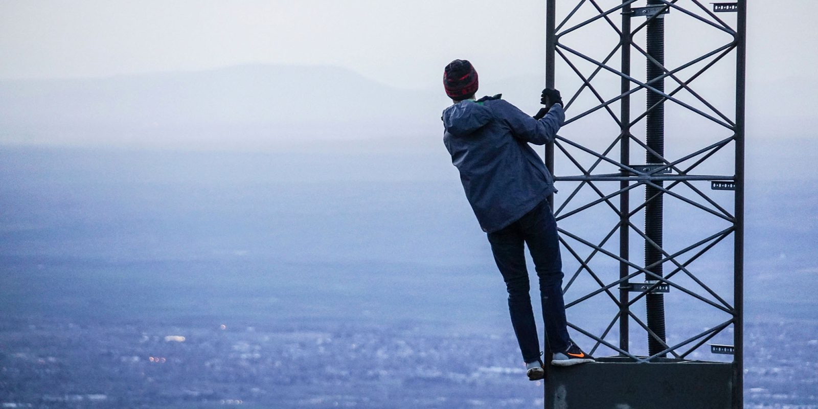 Scammers are faking cell towers now | Photo shows someone climbing a real one