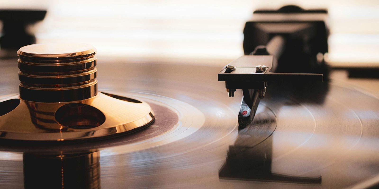 Spotify Free now lets you play a specific track on demand | Photo shows vinyl record player with a linear tracking arm