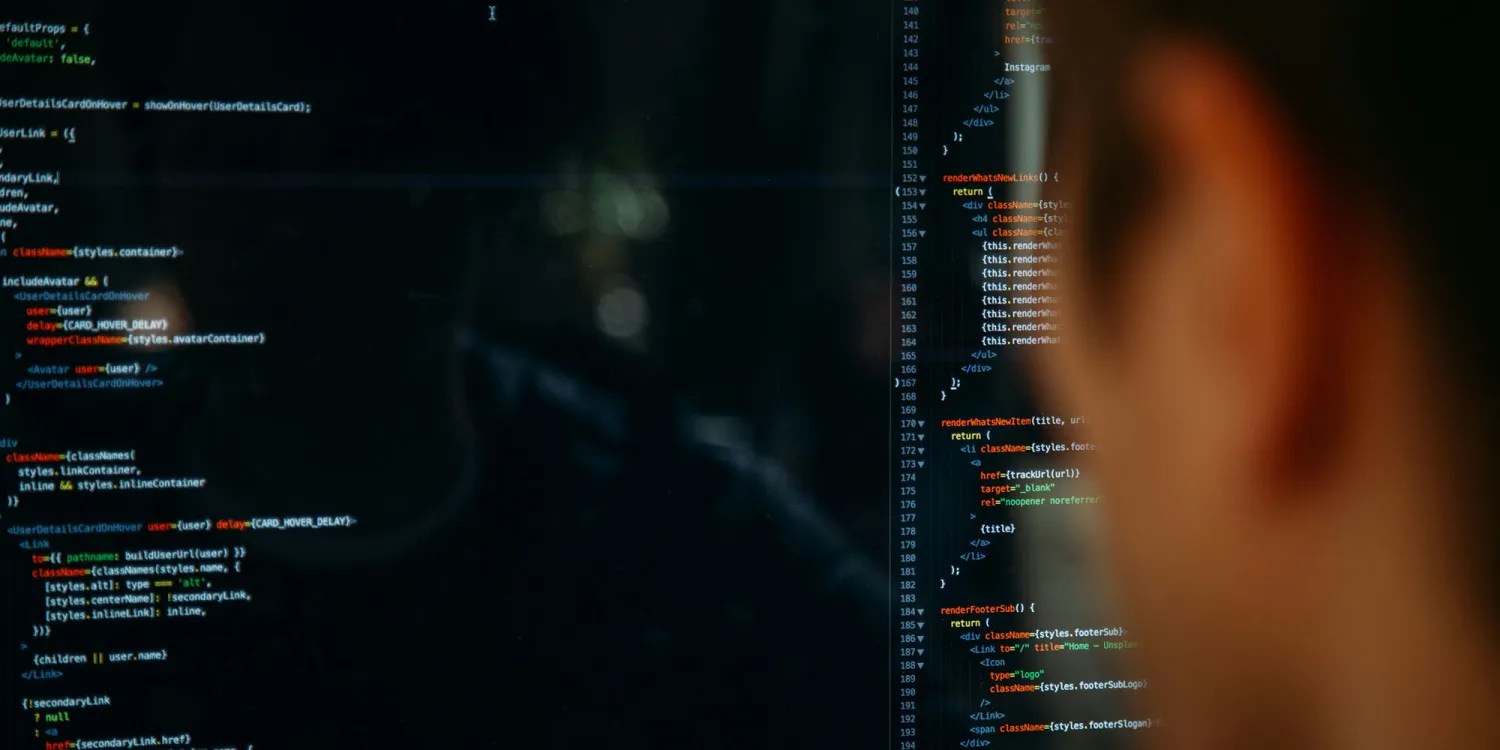 TransUnion data breach hits millions, but Gmail security reports are false | Photo shows back of a man's head looking at code on a monitor