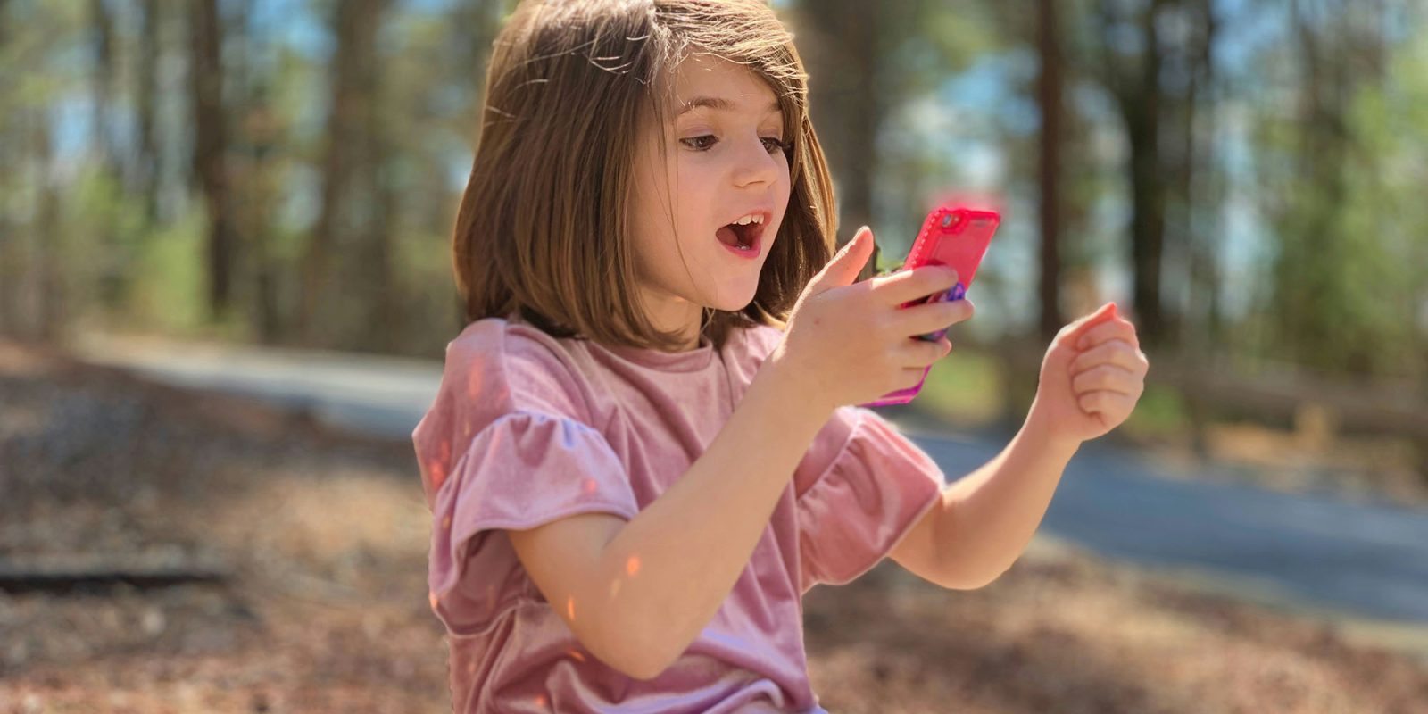 Meta and TikTok failed to protect children, says EU | Photo shows a young girl looking at her phone