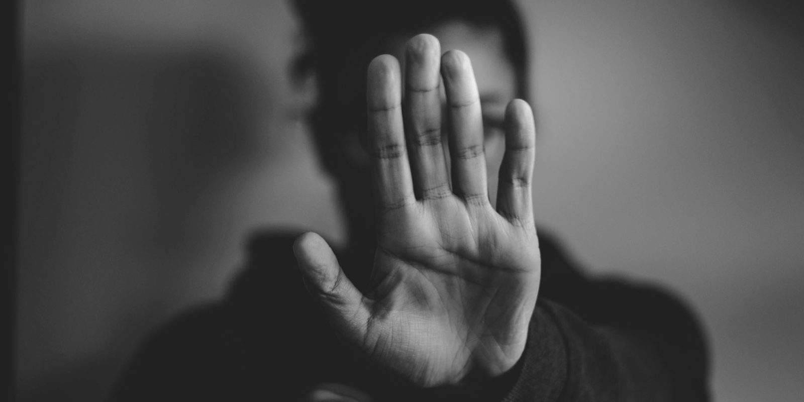 China forces Apple to remove the most popular gay dating apps | Stock photo of a woman holding up a hand in a Stop gesture