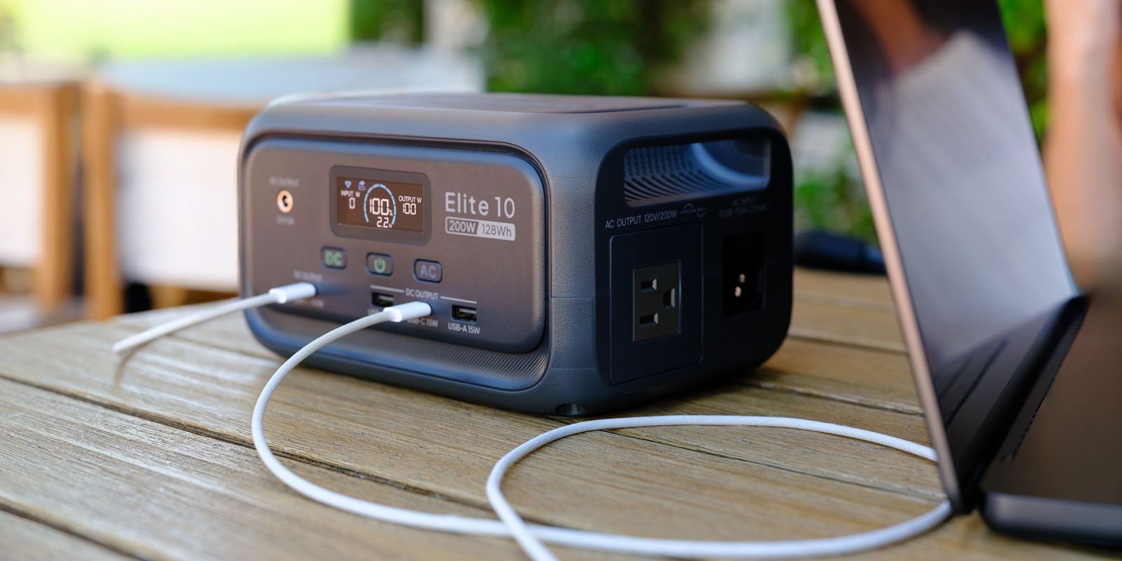 Elite 10 Portable Power Station (pictured on a garden table with a laptop)
