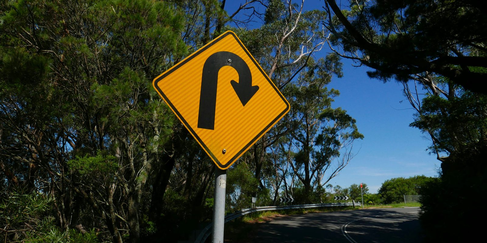 After Apple refusal, Indian government makes complete U-turn on mandatory iPhone app | Photo shows a U-turn sign ahead of a bend