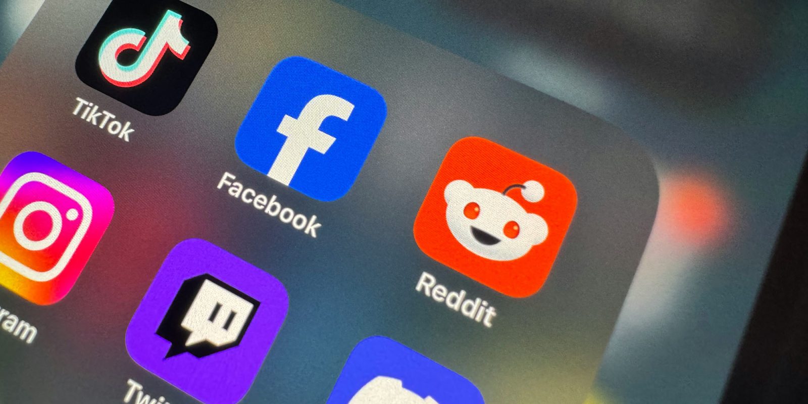 Reddit making global changes to protect kids after social media ban | Photo shows a close-up of social media apps on an iPhone