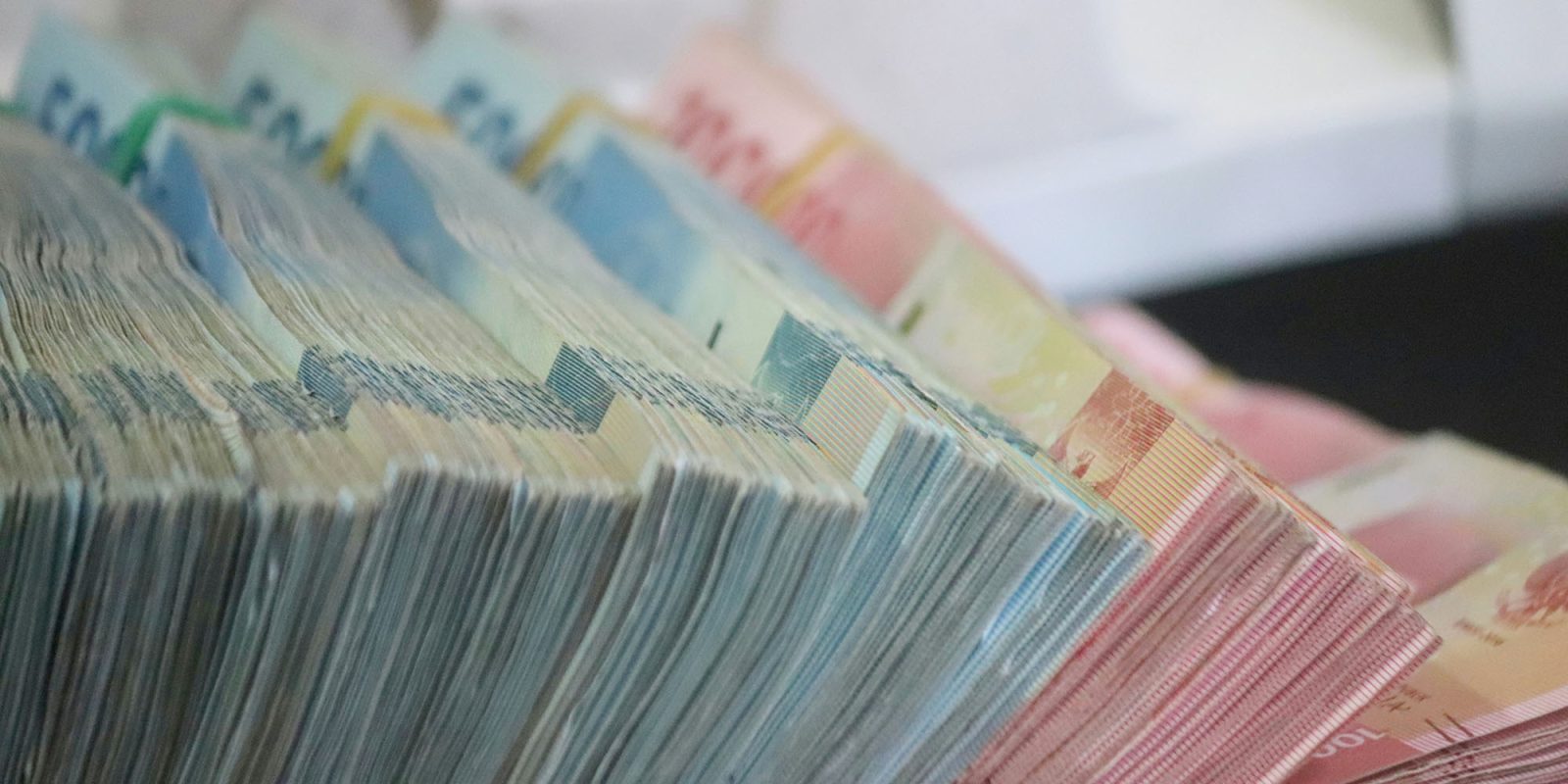 Apple was fined a total of $851M last year for privacy and antitrust violations | The photo shows large stacks of banknotes