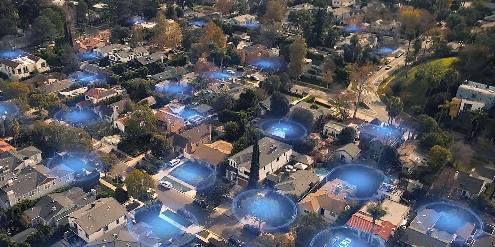Tone-deaf Ring Search Party feature sparks public backlash | Image shows an aerial view of a residential neighborhood with blue circles activated